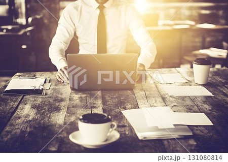 Businessman working on laptop with coffee and documents on rusti 131080814