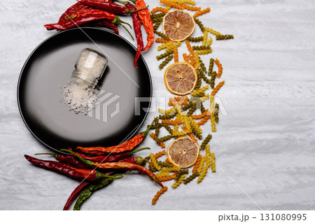 salt on black ceramic plate with ingredients 131080995