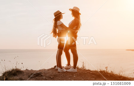 Two Women Embrace on a Clifftop at Sunset 131081009