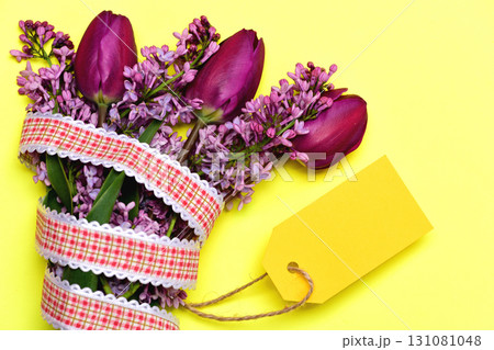 Delivered bouquet with purple tulips and lilac flowers Delivered bouquet with purple tulips and lilac flowers 131081048