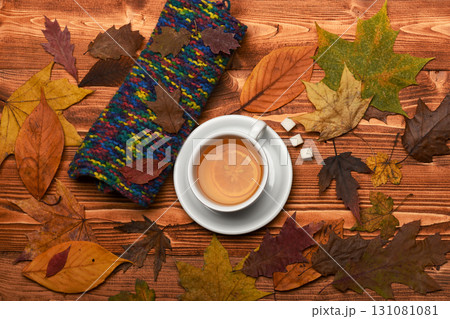 Cup of green tea with slice of lemon near leaves 131081081