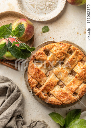 Homemade Apple Pie with fresh apples on textured background top view. Thanksgiving traditional dessert, autumn baking, recipe Homemade Apple Pie with fresh apples on textured background top view. Thanksgiving traditional dessert, autumn baking, recipe 131082370