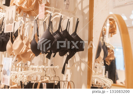 Various lingerie styles on hangers in clothing boutique. Ideal for themes of retail, underwear, fashion 131083200