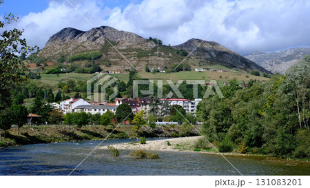 A scenic view of a river flowing through a small town, Arriondas in Asturias, Spain. A scenic view of a river flowing through a small town, Arriondas in Asturias, Spain. 131083201