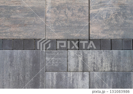 Pattern of paving stones in gray and white shades with rough textured surface. Concept of pavement, stone pattern, construction for decorative outdoor flooring, natural background Pattern of paving stones in gray and white shades with rough textured surface. Concept of pavement, stone pattern, construction for decorative outdoor flooring, natural background 131083986