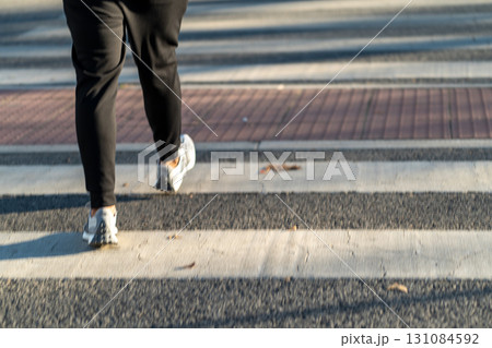 Walking on a Crosswalk During a Sunny Day in an Walking on a Crosswalk During a Sunny Day in an 131084592