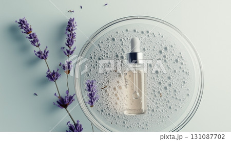 Lavender flower extract and glass bottle liquid in glass plate sample, wellness natural ingredient 131087702