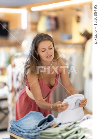 Girl customer chooses shorts in store 131088495