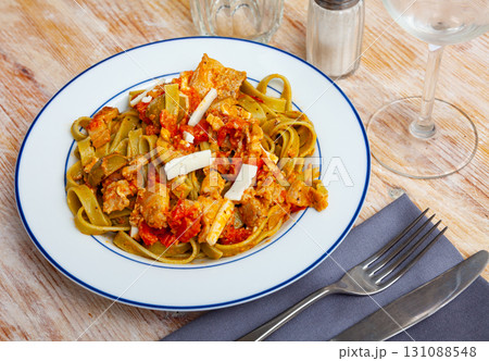 Italian spinach tagliatelle pasta with tomato sauce 131088548