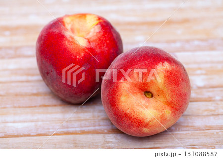 Delicious ripe peaches fruit on wooden surface in kitchen Delicious ripe peaches fruit on wooden surface in kitchen 131088587