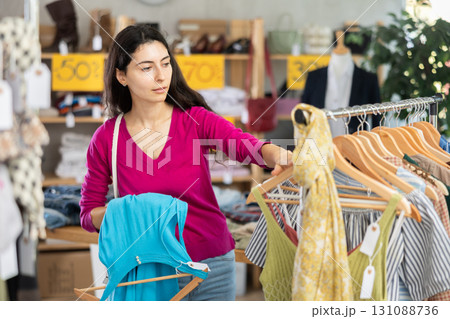 Armenian woman chooses a summer dress on sale Armenian woman chooses a summer dress on sale 131088736