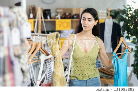 Armenian woman chooses a summer dress on sale 131088892