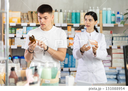 Man choosing pills with help from pharmacist Man choosing pills with help from pharmacist 131088954