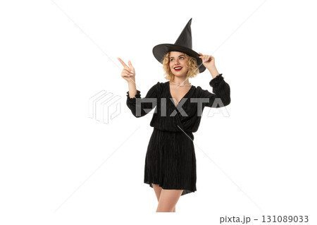 Cheerful witch shows off Halloween spirit, isolated on white, PNG 131089033