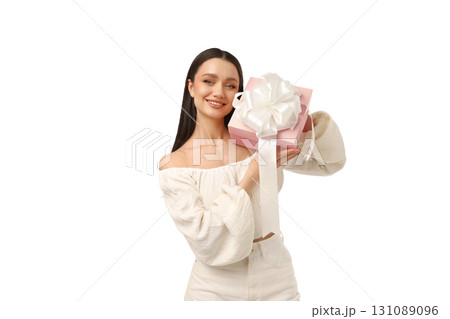 Joyful woman with a wrapped gift, isolated on white, PNG 131089096