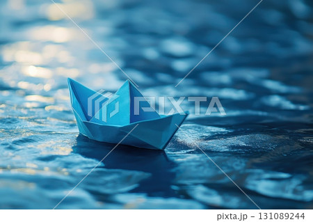 A small paper boat is floating on the surface of the water A small paper boat is floating on the surface of the water 131089244