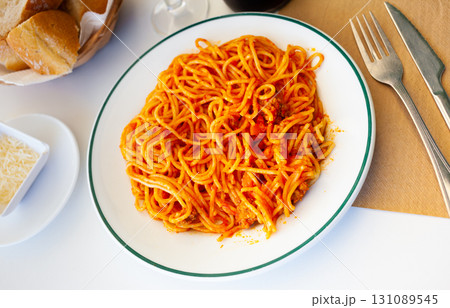 Plate of Italian spaghetti topped with ground beef Bolognese sauce Plate of Italian spaghetti topped with ground beef Bolognese sauce 131089545