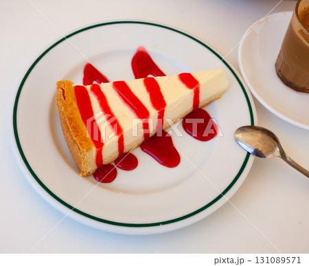 Slice of tasty creamy cheesecake with berries jam Slice of tasty creamy cheesecake with berries jam 131089571