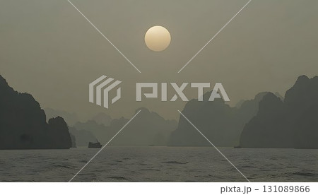 Hazy Sun Over Limestone Karsts and Boat on Calm Waters 131089866
