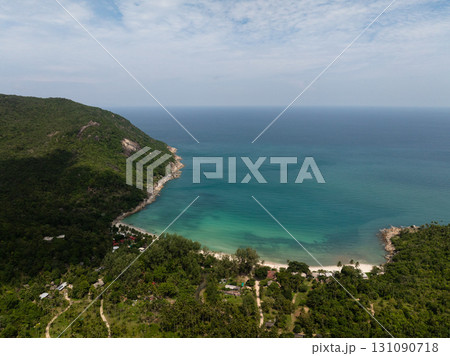 A tropical bay with turquoise waters, sandy beach, and lush green hills under a bright sky. Ko Pha Ngan, Thailand. A tropical bay with turquoise waters, sandy beach, and lush green hills under a bright sky. Ko Pha Ngan, Thailand. 131090718