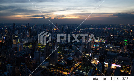 Twilight view of Bangkok with skyscrapers lit up, creating a stunning urban nightscape under a colorful evening sky. Bangkok, Thailand. Twilight view of Bangkok with skyscrapers lit up, creating a stunning urban nightscape under a colorful evening sky. Bangkok, Thailand. 131090722