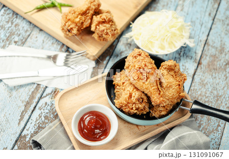 Crispy Fried chicken with tomato sauce on grunge background table. Fast food unhealthy. 131091067