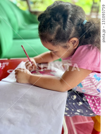 Little girl drawing with colored pencils in the living room at home Little girl drawing with colored pencils in the living room at home 131093759