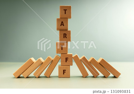 Falling dominoes halted by a vertical stack labeled TARIFF, Trade barriers affect global economies in domino impact Falling dominoes halted by a vertical stack labeled TARIFF, Trade barriers affect global economies in domino impact 131093831