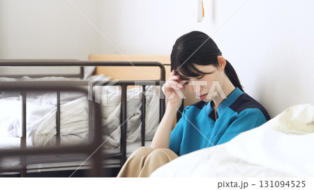 介護の仕事で疲れるアジア人介護士 131094525