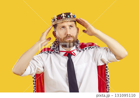 Corporate employee in king's crown and office shirt dreams of getting boss position 131095110
