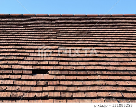 A Classic Clay Tile Roof against a beautiful Blue Sky backdrop A Classic Clay Tile Roof against a beautiful Blue Sky backdrop 131095255