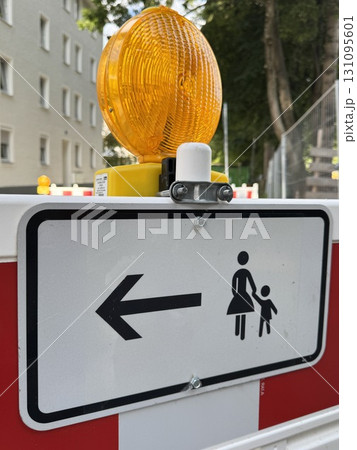 Caution Sign Featuring a Pedestrian Direction Indicator for Enhanced Safety Awareness 131095601