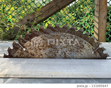 A Rusty Circular Saw Blade is resting on a Workshop Table, ready for various tasks ahead 131095647
