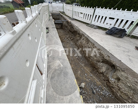 Construction Site Featuring an Exposed Trench for Essential Utility Work Being Conducted Construction Site Featuring an Exposed Trench for Essential Utility Work Being Conducted 131095850