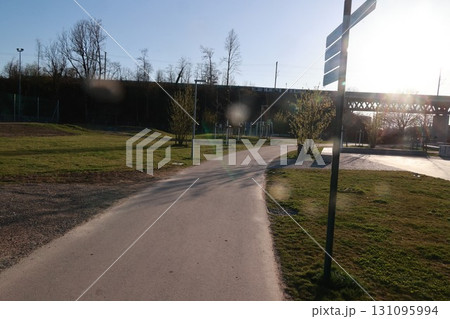 A path in a park with a sign on the right 131095994