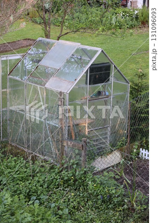 A greenhouse with a fence around it 131096093