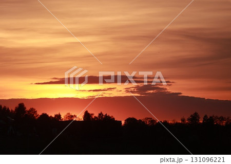 The sky is orange and the sun is setting 131096221