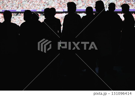 Group of people are standing in a stadium Group of people are standing in a stadium 131096414