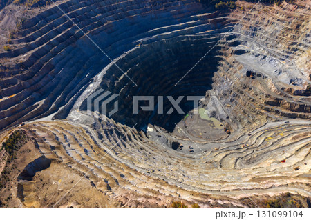 Flying above an open pit mine, copper excavation in Rosia Poieni, Romania. Aerial view 131099104