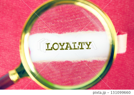 LOYALTY word was found using a magnifying glass under a piece of paper. Fake Dictionary, Dictionary definition concept. LOYALTY word was found using a magnifying glass under a piece of paper. Fake Dictionary, Dictionary definition concept. 131099660