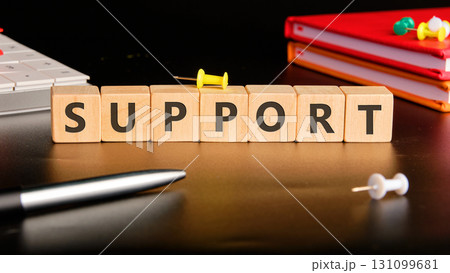 The concept word SUPPORT has been collected of wooden cubes on a black background with stationery next to it. Business and SUPPORT concept. Copy space The concept word SUPPORT has been collected of wooden cubes on a black background with stationery next to it. Business and SUPPORT concept. Copy space 131099681