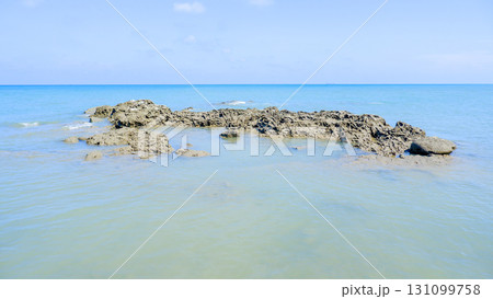 Long Coastal Rock Formation in a Calm Tropical Sea Long Coastal Rock Formation in a Calm Tropical Sea 131099758