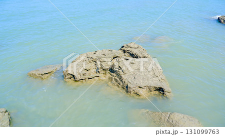 Rugged Coastal Rock in Clear Shallow Water 131099763