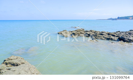 Calm Tropical Seascape with a Distant Coastline 131099764
