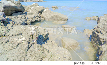 Close-up of Rugged Coastal Boulders and Clear Water 131099768