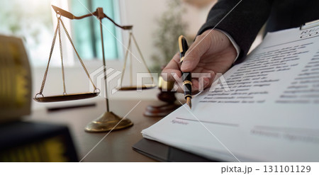 Lawyer with scales of justice and legal documents Lawyer with scales of justice and legal documents 131101129