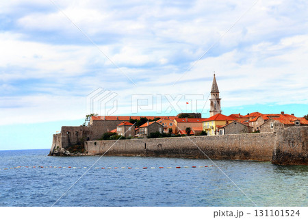 Old town, fortress wall and Adriatic sea, Budva, Montenegro. Beautiful scene with medieval houses and seascape. Topic of summer vacation, travel, cruises and tours Old town, fortress wall and Adriatic sea, Budva, Montenegro. Beautiful scene with medieval houses and seascape. Topic of summer vacation, travel, cruises and tours 131101524