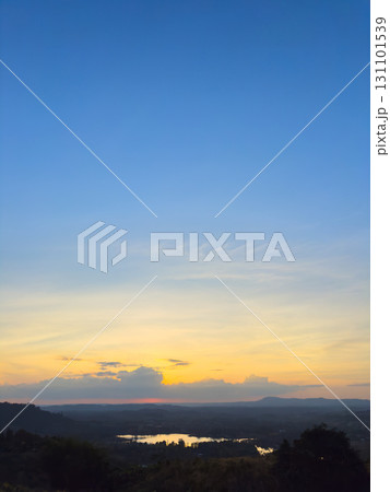 Vertical wide view of lake and forest with sunset sky 131101539