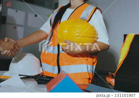 Closeup of team of industrial engineers meeting analyze machinery blueprints consult project on table in manufacturing factory. Working in manufacturing plant or production plant. 131101907