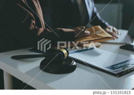 Lawyer explained to the client about the law that must be brought against the court case. Lawyer explained to the client about the law that must be brought against the court case. 131101923
